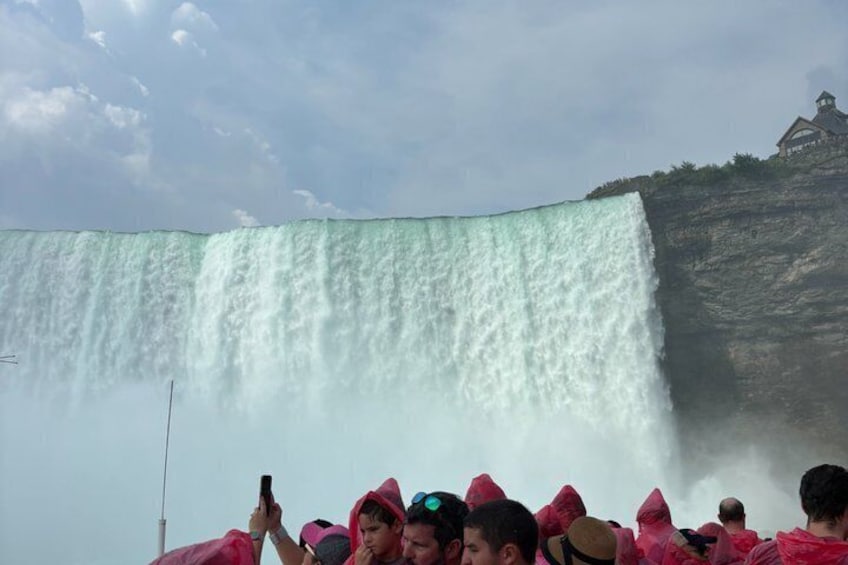 A large waterfall with a crowd of people in the foreground. 3