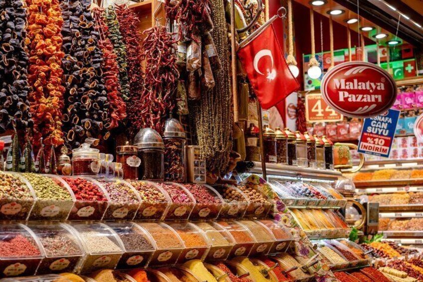A spice market with various dried herbs and spices displayed in containers. 3