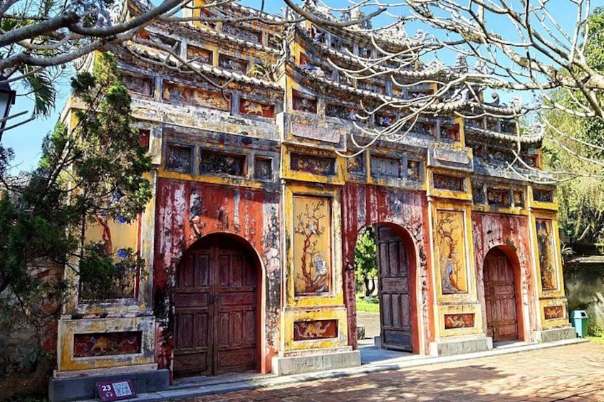 A traditional building with ornate architecture, featuring multiple doors and intricate designs. 3