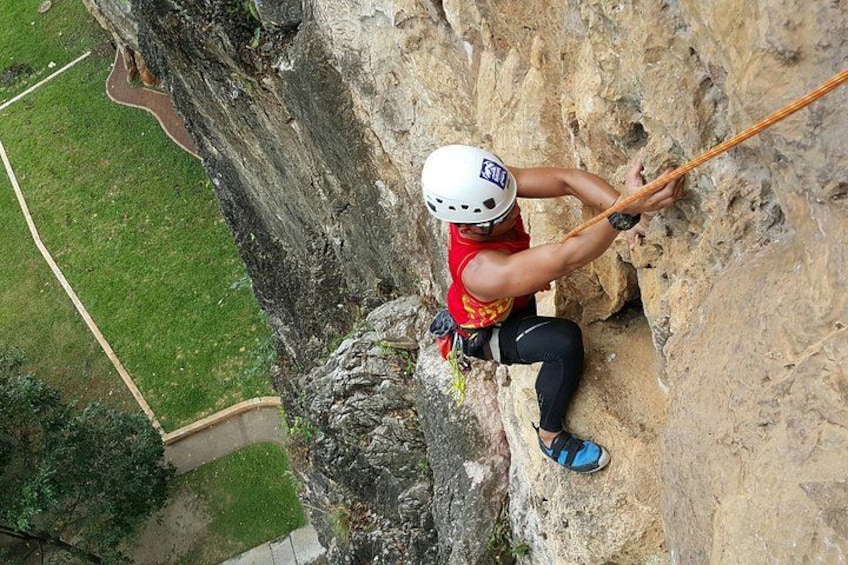 A person rock climbing on a cliff. 1