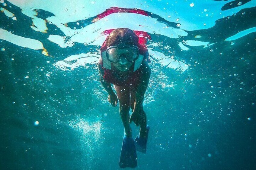 A person swimming underwater. 1