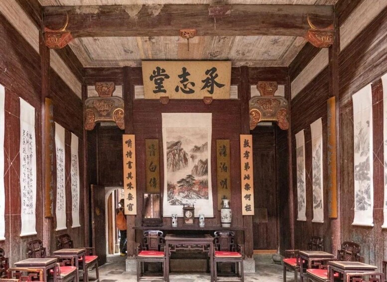 A traditional Chinese room with wooden beams, calligraphy scrolls, and a central painting. 3