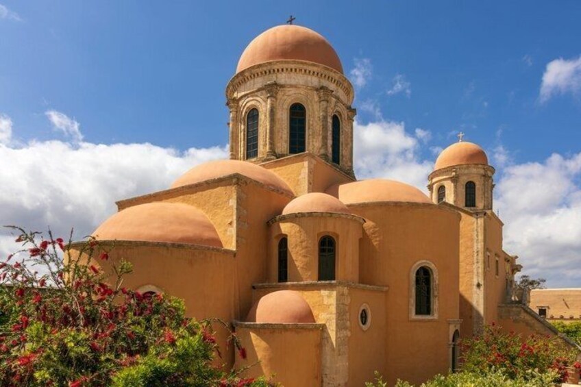 A church with multiple domes and a clear blue sky. 4