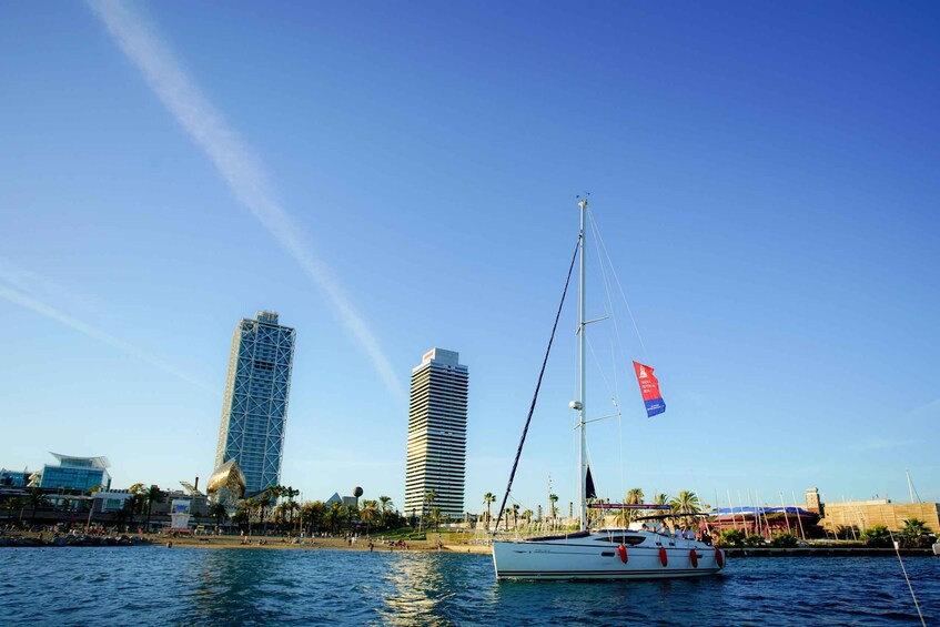 A sailboat on calm waters with a city skyline in the background. 5