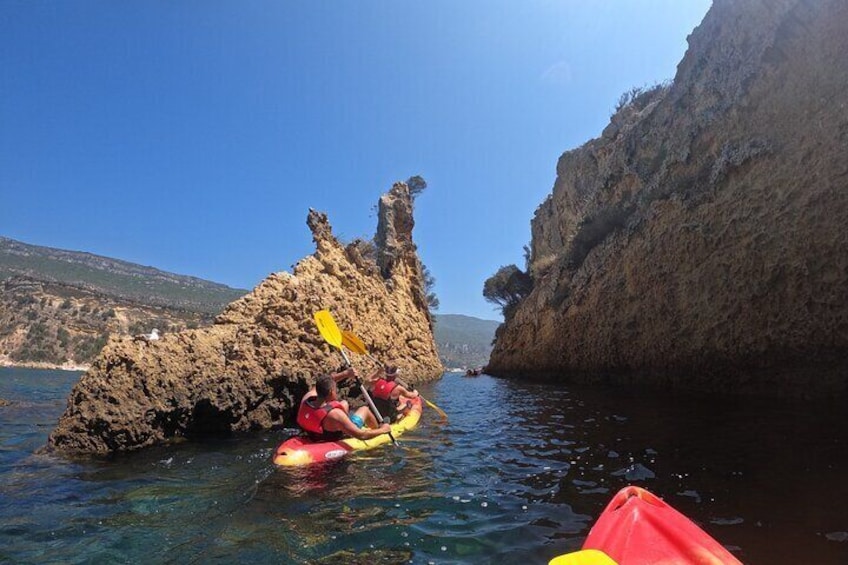 A kayak navigating a narrow waterway between rocky cliffs. 5