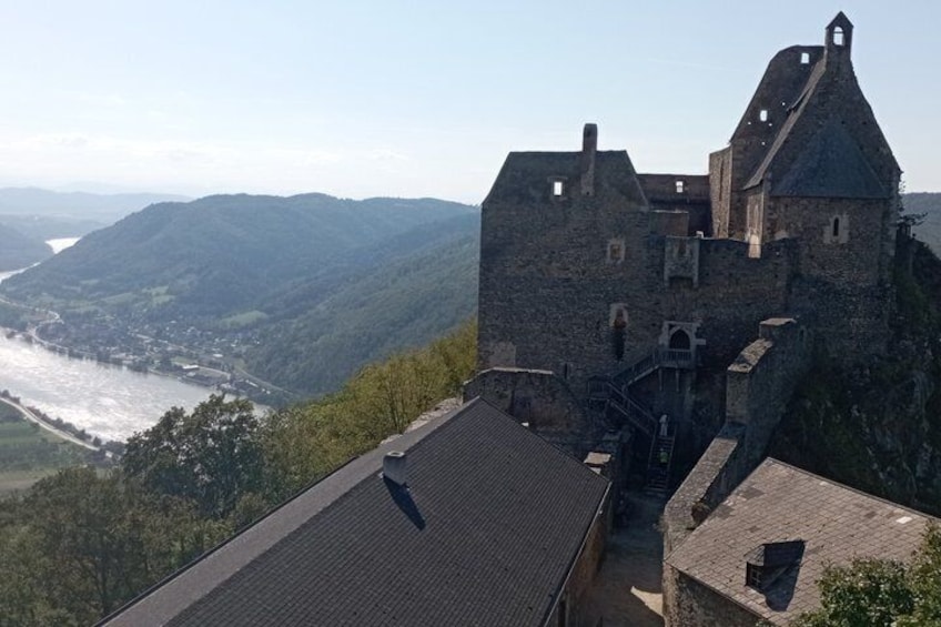 A historic stone castle overlooking a river valley. 4