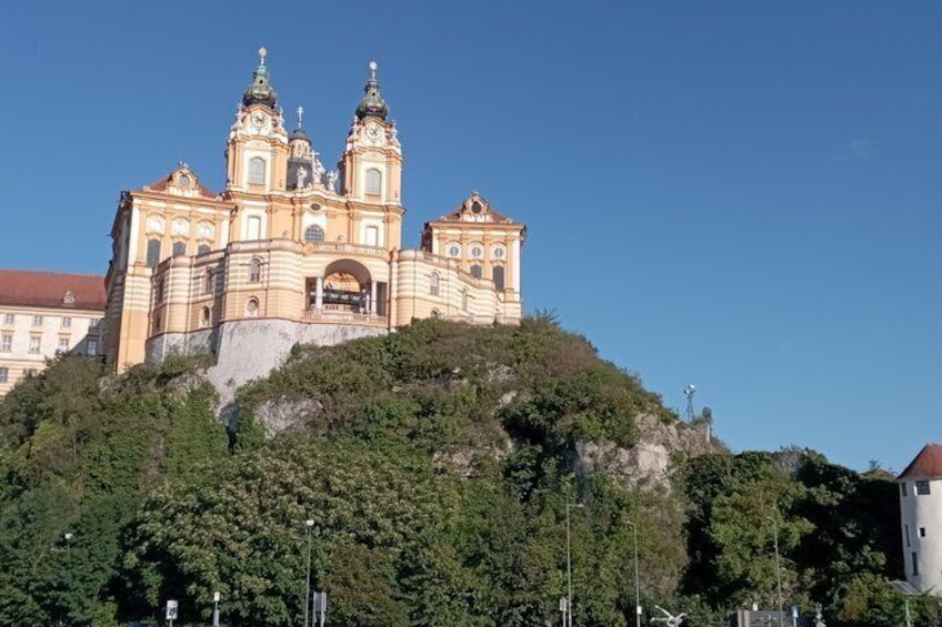 A large, ornate church with two towers, situated on a hill with dense greenery. 5