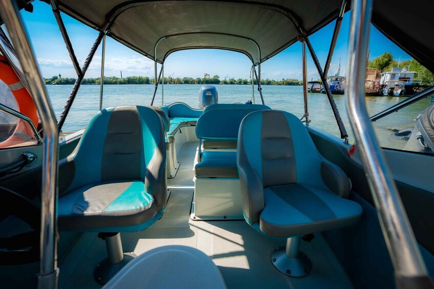 A boat interior with two seats and a steering wheel. 3