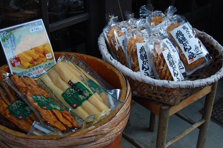 A display of packaged snacks and bread in a market setting. 2