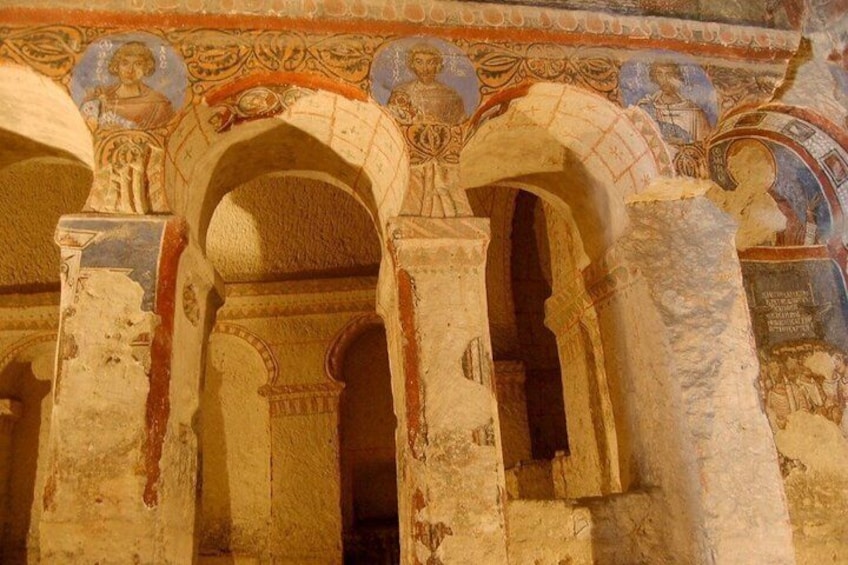An ancient architectural structure with arched passageways and mosaic decorations. 3