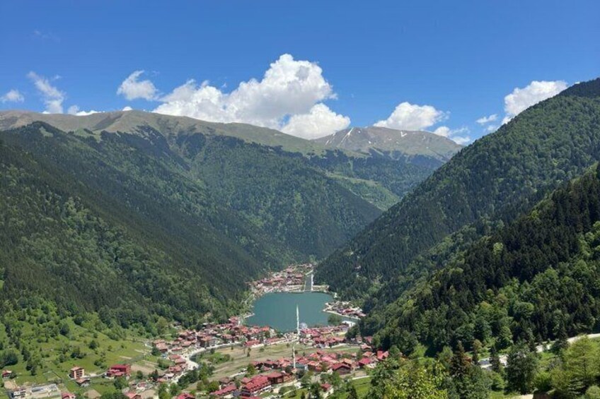 A mountainous landscape with a lake, a church, and a village. 4