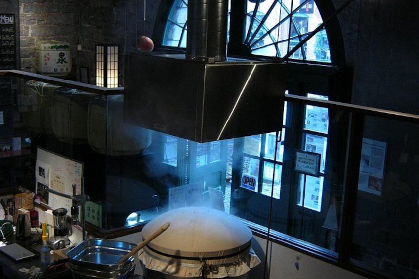A kitchen with a large oven, a window, and various cooking utensils. 4
