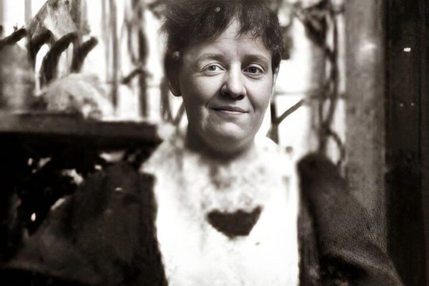 A person in a black and white setting with a heart-shaped object on their chest. 2