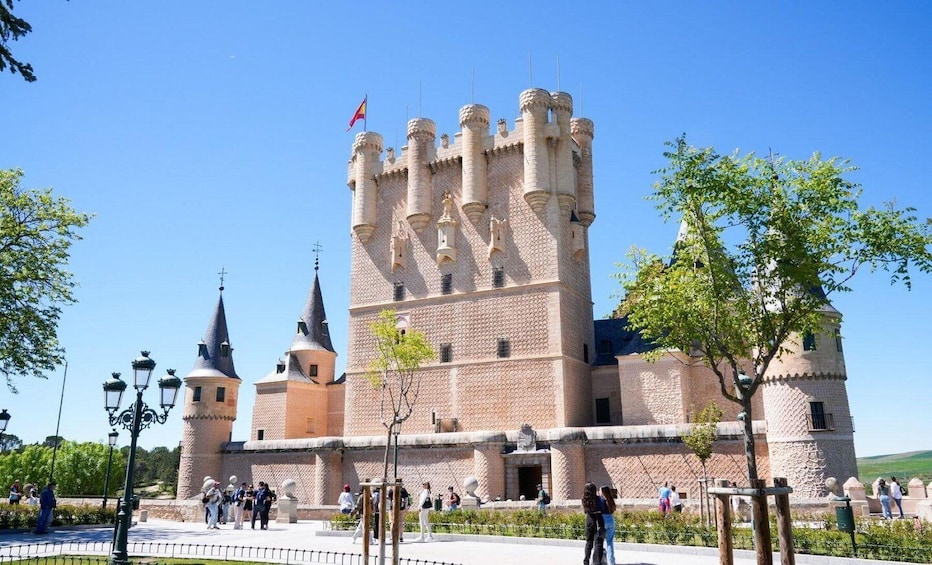 A historic castle with multiple towers and a flag. 5