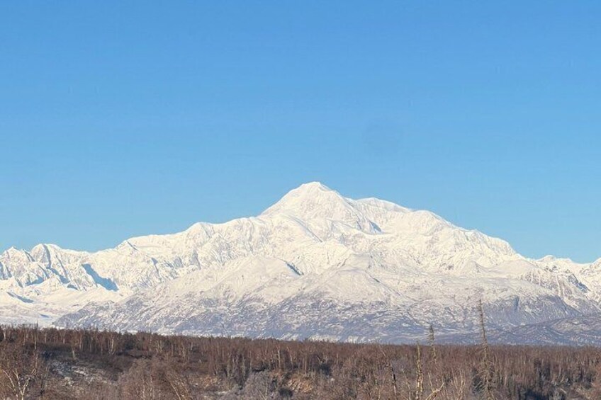 A snow-covered mountain range with clear skies. 4