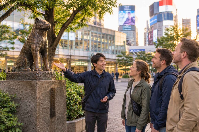 A bronze statue of a bear on a pedestal in an urban park with modern buildings in the background. 5