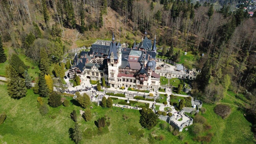 A large, historic estate surrounded by forested hills. 2