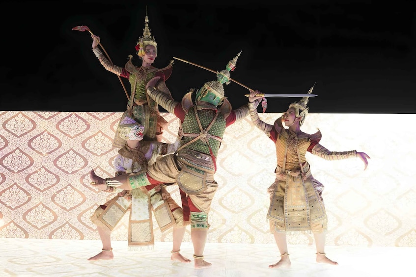 A traditional dance performance with elaborate costumes and props. 2