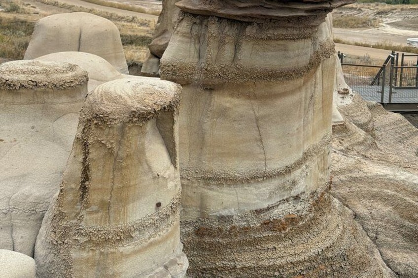 A close-up of ancient stone columns with weathered textures and inscriptions. 4