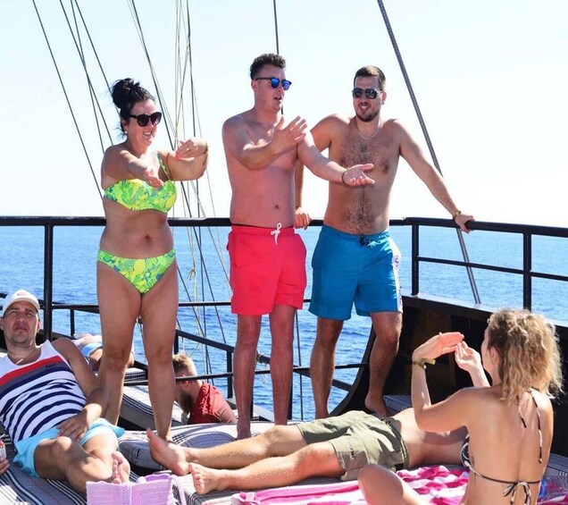 People on a boat with the ocean in the background. 3