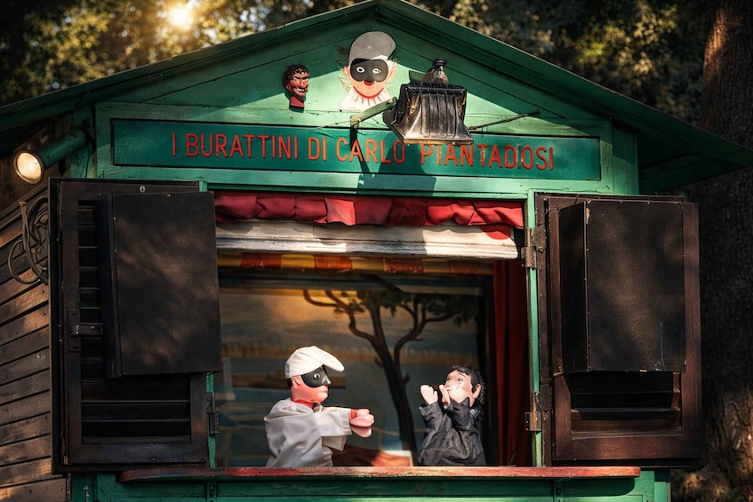 A small wooden structure with a sign reading 'I Buratti di Carlo Piantedosi.' 5