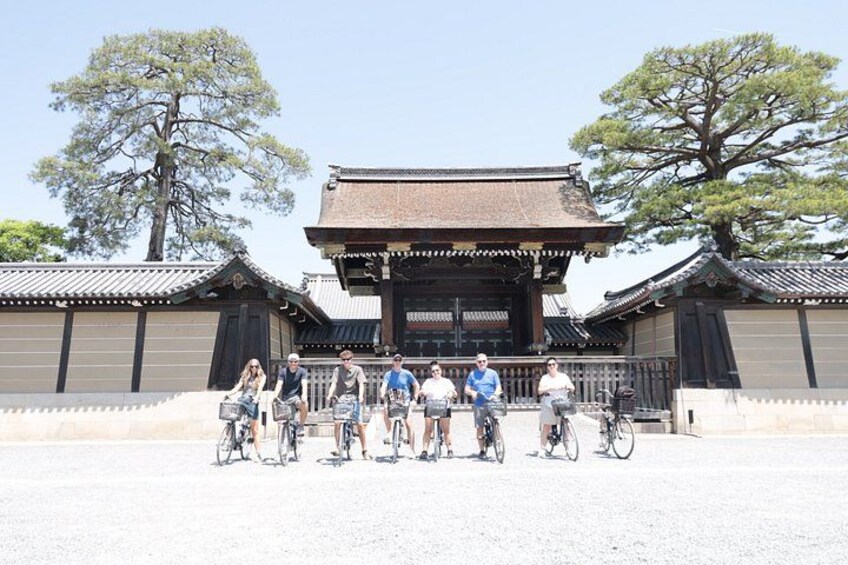 A traditional Japanese building with a tiled roof and wooden structure, surrounded by trees. 1
