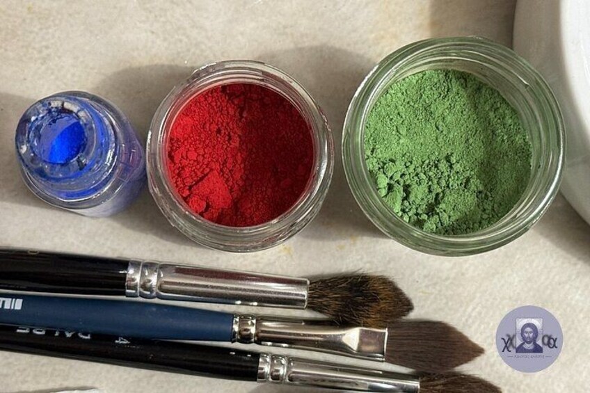 Paintbrushes, a jar of red pigment, and a jar of green pigment. 3