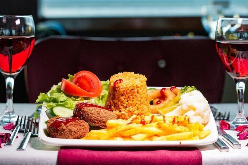 A plate of food with fries, a burger, and a salad. 1