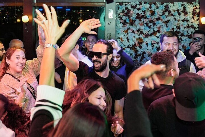 A group of people dancing at a social event. 4