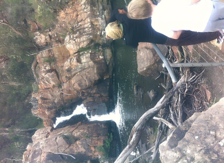 A rocky cliff with a waterfall. 5