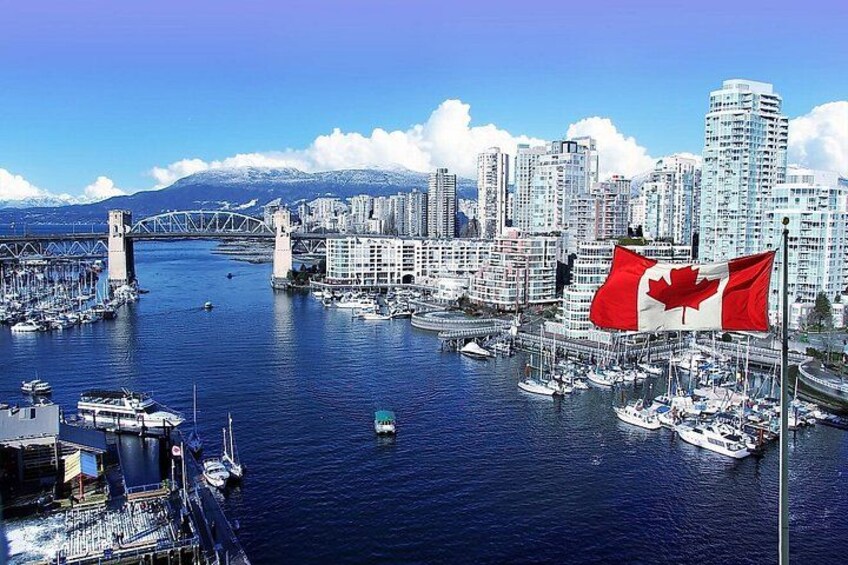 A harbor with boats, a bridge, and a city skyline with high-rise buildings. 5