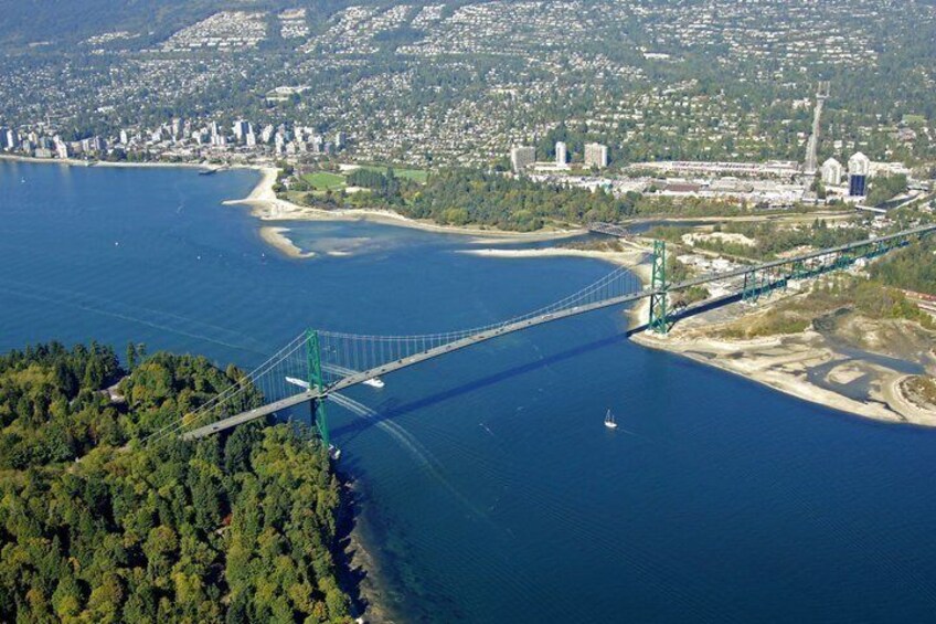A suspension bridge over a river, a coastal cityscape, and a forested area. 2