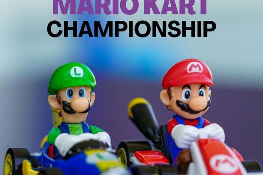Two Mario Kart figurines on go-karts with the text 'MARIO KART CHAMPIONSHIP' above them. 2