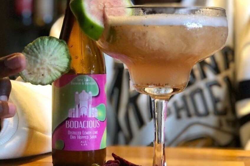 A bottle of Bodacious Distilled Lemon Lime Dry Hopped Sour with a lime slice garnish. 1
