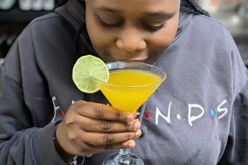 A person holding a martini glass with a lime wedge. 3