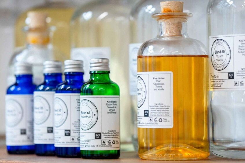 A row of perfume bottles with labels indicating different scents and alcohol content. 2