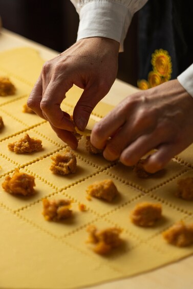 Hands shaping dough on a baking sheet. 5