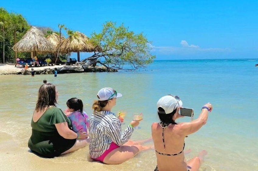 A beach with people sitting and taking photos. 5
