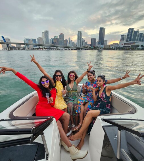 A group of people on a boat with a city skyline in the background. 1