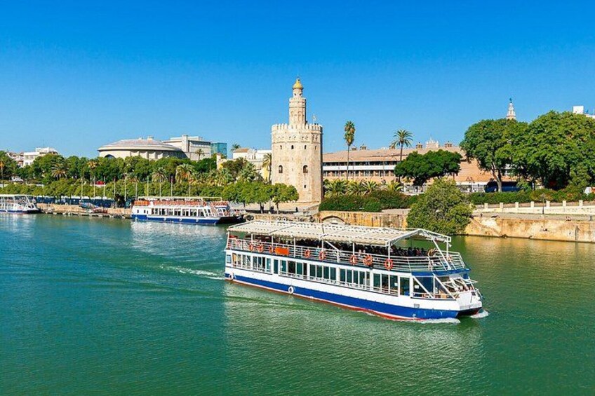 A river with a boat, a historic tower, and a bridge. 2