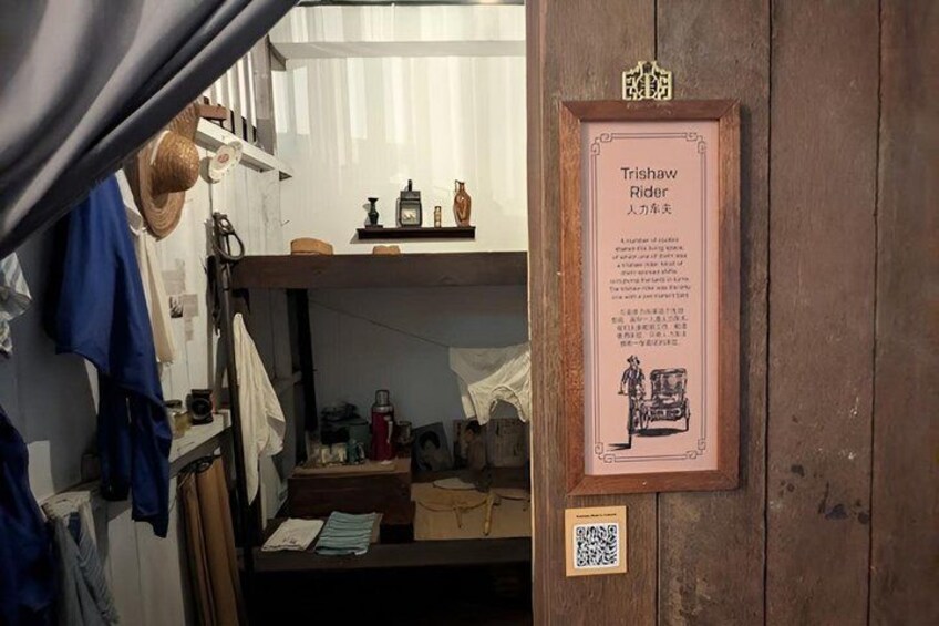 A rustic interior with a wooden door, a framed sign, and various household items. 2