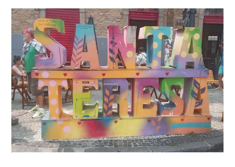 A colorful Santa Teresa sign with heart decorations. 3