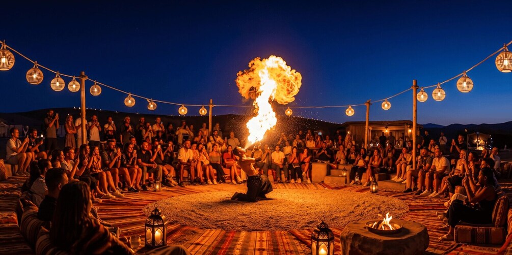 A fire performance in a circle surrounded by an audience. 5
