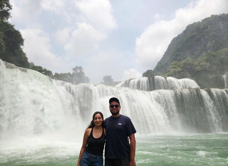 A waterfall with a person and a child in front. 5