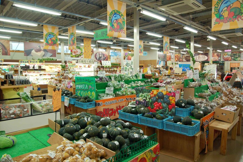 A grocery store with various produce and packaged goods on display. 2