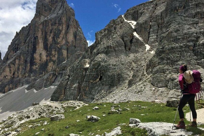 A hiker with a backpack on a rocky mountain trail. 1