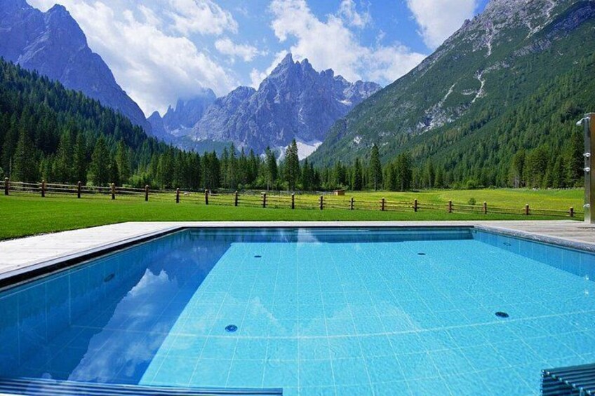 A swimming pool with a mountain backdrop. 2