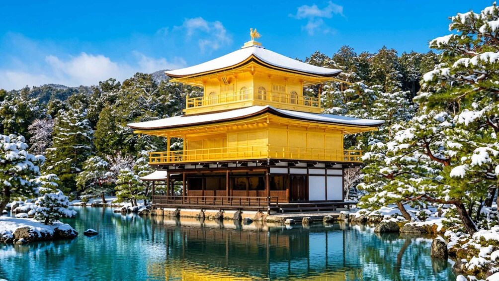 A traditional Japanese temple with a golden roof, surrounded by snow-covered trees and a calm lake. 1