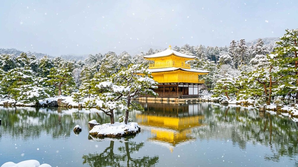 A traditional yellow building surrounded by snow-covered trees and a calm lake. 3