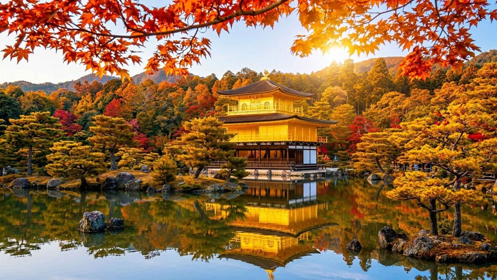A traditional Japanese building with a reflection in a calm pond, surrounded by autumn-colored trees. 1